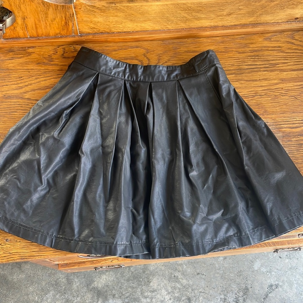 Black leather skirt. Not sure what brand.